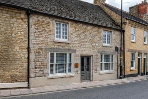 a brick building with white windows on a street at Luxury town centre loft apartment in converted Granary in Stamford