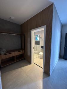 ein Badezimmer mit einem WC und einer Glasschiebetür in der Unterkunft Hotel Cidade Araxá in Araxá