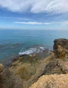 a view of the ocean from the top of a cliff at Loft, muy cerca de playa y castillo Tamarit in Tarragona