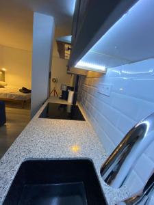 a kitchen with a sink and a counter top at Loft, muy cerca de playa y castillo Tamarit in Tarragona