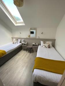 a hotel room with two beds and a skylight at The Town House Hotel in Naas
