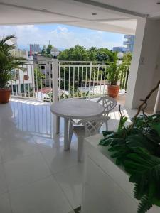 a white balcony with a table and chairs on a patio at Kandi comfortable 1bedroom, king bed, housekeeping in Angeles