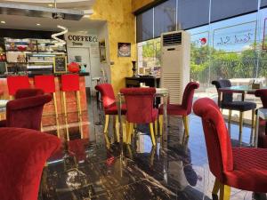 a restaurant with red chairs and a table at Sheryll Escapes - Kandi comfortable 1bedroom, king bed, housekeeping in Angeles