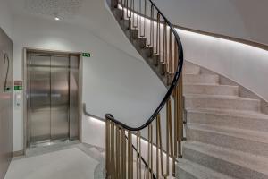 a staircase in a building with a metal elevator at Acta The Clover in Porto