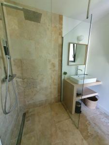 a bathroom with a shower and a sink at L'Instant Luberon in Gordes