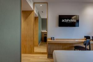 a room with a bed and a mirror and a desk at Acta The Clover in Porto