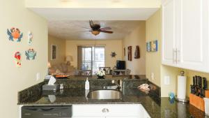 a kitchen with a sink and a ceiling fan at 9141 Lake #102 in Englewood