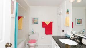 a bathroom with a toilet and a sink at 9141 Lake #102 in Englewood