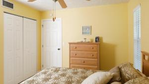 a bedroom with a bed and a dresser at 9141 Lake #102 in Englewood +18 photos