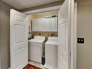 a white laundry room with a washer and dryer at Yes Deer in Oakland