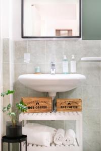 a bathroom with a sink and a mirror and towels at Green Coast House 5 in Piombino