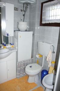 a bathroom with a toilet and a sink at Nice Apartment only 150 metres from the Beach by Beahost Rentals in Bibione