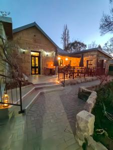 a stone house with a patio at night at Ing at Sandstone in Fouriesburg