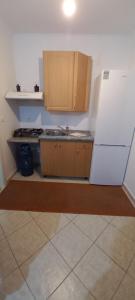 a kitchen with a sink and a white refrigerator at STUDIO R in Kanallákion