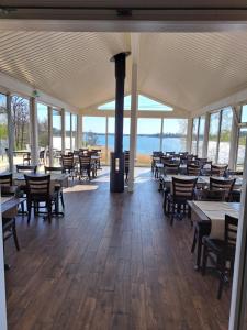 a dining room with tables and chairs and the ocean at Hotell Gullvivan in Brändö