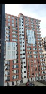 a large apartment building with many windows at Balavari Samgori Guest House in Tbilisi City