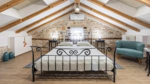 a bedroom with a black bed and a stone wall at Villa Francesca by Villas Holiday in Umag +32 photos