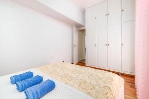 a bedroom with a bed with blue towels on it at Koukaki Apartment in Athens