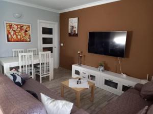 sala de estar con sofá y TV de pantalla plana en Vacaciones en Marbella, en Marbella