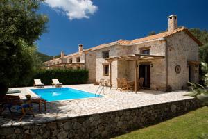 an external view of a house with a swimming pool at Aelia Villa in Sivota