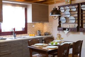 a kitchen with a table and chairs and a sink at Aelia Villa in Sivota