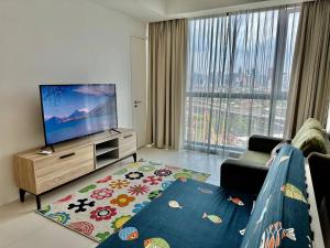 a living room with a couch and a flat screen tv at Luxury Condo Jalan Tun Razak in Kuala Lumpur