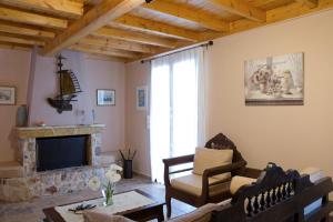 a living room with a couch and a fireplace at Aelia Villa in Sivota