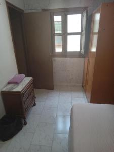 a bedroom with a bed and a dresser and a window at Penthouse 1 in Granada +29 photos
