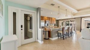 a kitchen and living room with a bar and chairs at 829 Napoli in Punta Gorda