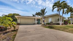 a house with a garage and palm trees at 829 Napoli in Punta Gorda