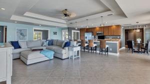 a large living room with a couch and a kitchen at 829 Napoli in Punta Gorda