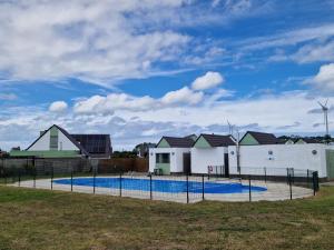 a swimming pool in front of some houses at Premium Holidays - modern vacation home in a vacation park in Nieuwpoort in Nieuwpoort