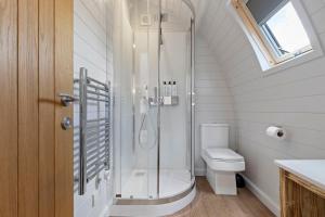 a bathroom with a shower and a toilet at Nestledstays- The Lake House in Arundel +34 photos