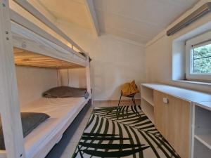 a room with two bunk beds and a window at Premium Holidays - modern vacation home in a vacation park in Nieuwpoort in Nieuwpoort