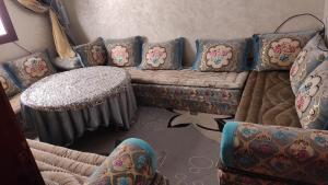 a living room with a couch and a table at ADAM 2 in Dakhla