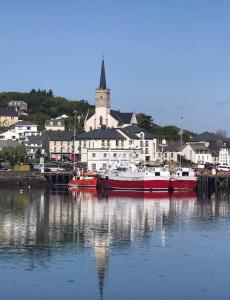 two boats are docked in a harbor with a city at Curragh View in Killybegs