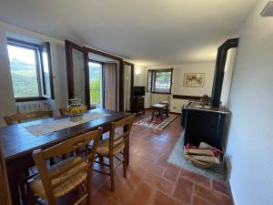 a kitchen and dining room with a table and a stove at Albergo Diana dèpendace Villa Primula in Monti di Pino