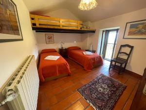 a bedroom with two beds and a chair in it at Villa Primula in Monti di Pino