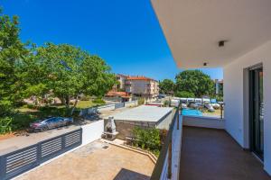 a balcony with a view of a parking lot at House Neptunia in Medulin