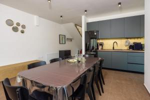 a dining room and kitchen with a table and chairs at House Neptunia in Medulin +43 photos