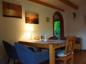 a dining room with a wooden table and blue chairs at Ferienhaus Hieve in Marienwehr
