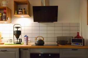 a kitchen with a counter top with a coffee maker at Ferienhaus Hieve in Marienwehr +10 photos