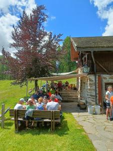 a group of people sitting on a bench at Baita Vioz in Peio