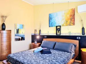 ein Schlafzimmer mit einem Bett mit blauen Kissen in der Unterkunft lovely house with garden in La Maddalena