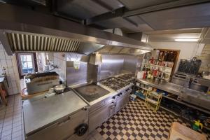 an overhead view of a restaurant kitchen with a stove at Landhotel für Familien und Firmen in Schönhagen