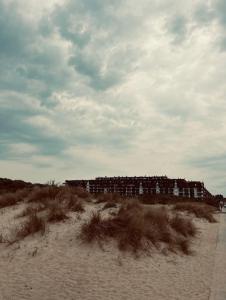 un bâtiment situé sur la plage près du sable dans l'établissement CREVETTE Gezellig appartement met zonnige terrassen en zeezicht - Toplocatie!, à Coxyde