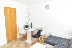 a room with a table and chairs and a bed at Apartment Centar in Postira