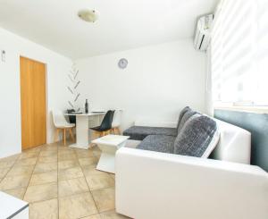 a living room with a couch and a table at Apartment Centar in Postira