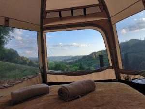 a bedroom with a view of a mountain view from a tent at Glamping Rožnov in Rožnov pod Radhoštěm