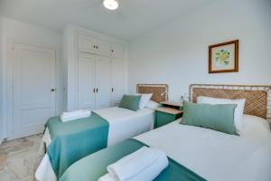 twee bedden in een kamer met wit en groen bij VB Myramar 2BDR Sun & Calm in Benalmádena